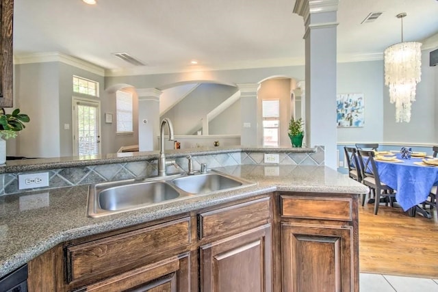 207 Knox St, Houston, TX 77007 - kitchen with arched walkways, visible vents, ornate columns, and a sink