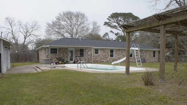 back of property featuring brick siding, a lawn, a patio, and fence