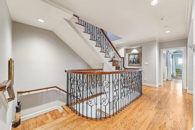 stairs with recessed lighting, baseboards, crown molding, and wood finished floors