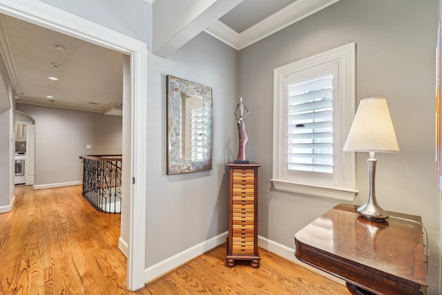 corridor featuring crown molding, baseboards, light wood-type flooring, and an upstairs landing