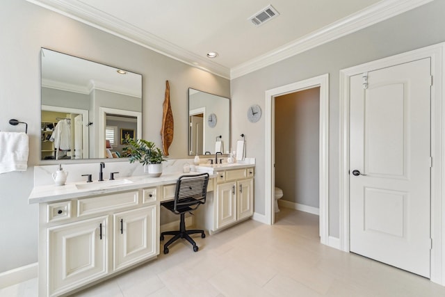 full bath featuring double vanity, crown molding, toilet, visible vents, and a sink