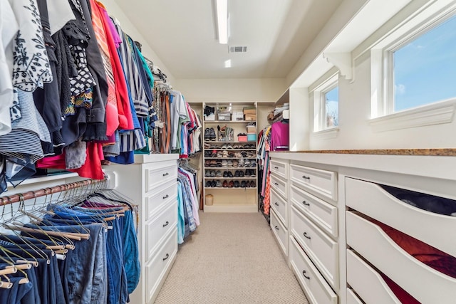 walk in closet with visible vents and light colored carpet