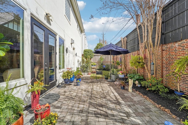 view of patio / terrace featuring french doors and fence