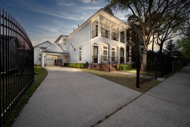 805 Columbia St, Houston, TX 77007 - view of front of home with a balcony, fence, a garage, concrete driveway, and an outdoor structure