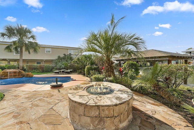 22102 Pecos Dr, Galveston, TX 77554 - view of patio / terrace with an outdoor pool and a fire pit