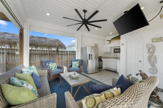 22102 Pecos Dr, Galveston, TX 77554 - view of patio / terrace featuring area for grilling, a ceiling fan, a sink, fence, and an outdoor hangout area