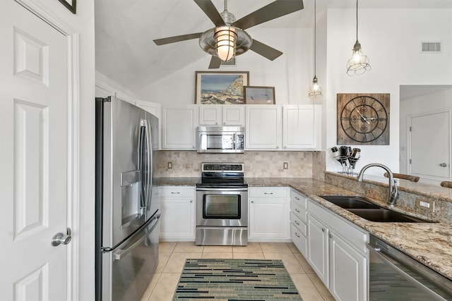 22102 Pecos Dr, Galveston, TX 77554 - kitchen with visible vents, ceiling fan, a sink, white cabinets, and appliances with stainless steel finishes