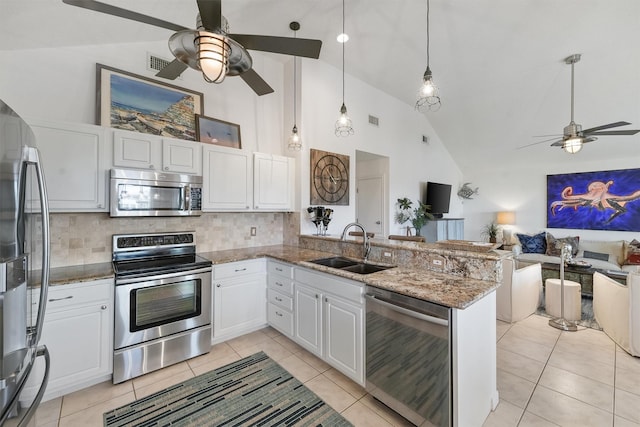 22102 Pecos Dr, Galveston, TX 77554 - kitchen with visible vents, a ceiling fan, a sink, open floor plan, and appliances with stainless steel finishes