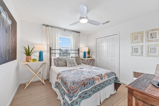 22102 Pecos Dr, Galveston, TX 77554 - bedroom with visible vents, a textured ceiling, a closet, carpet flooring, and baseboards