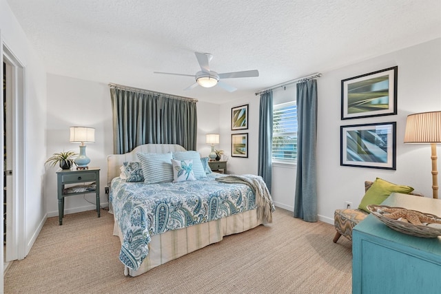 22102 Pecos Dr, Galveston, TX 77554 - bedroom featuring light colored carpet, baseboards, a textured ceiling, and a ceiling fan