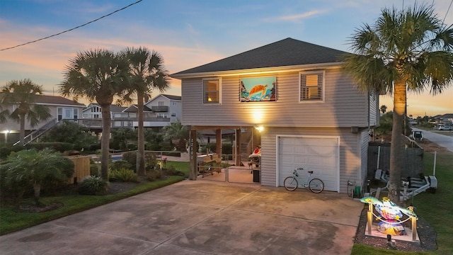 22102 Pecos Dr, Galveston, TX 77554 - view of front facade with concrete driveway and a garage