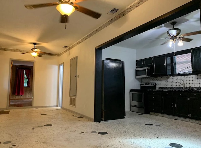 kitchen with dark cabinetry, visible vents, ceiling fan, appliances with stainless steel finishes, and light speckled floor