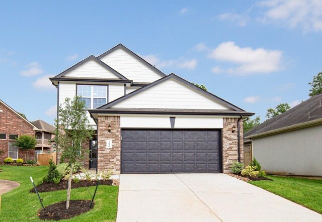 3626 Spy Glass Hill Dr, Montgomery, TX 77356 - view of front of house featuring an attached garage, a front lawn, brick siding, and driveway