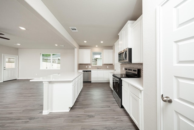 3626 Spy Glass Hill Dr, Montgomery, TX 77356 - kitchen featuring stainless steel appliances, tasteful backsplash, visible vents, and a wealth of natural light