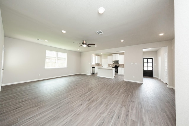 3626 Spy Glass Hill Dr, Montgomery, TX 77356 - unfurnished living room with a wealth of natural light, baseboards, and a ceiling fan