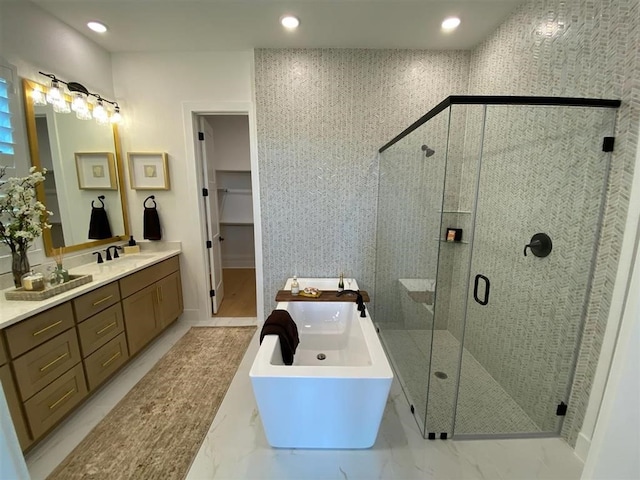 12039 Lake View Blvd, Mont Belvieu, TX 77523 - full bath with vanity, a stall shower, a freestanding bath, marble finish floors, and recessed lighting
