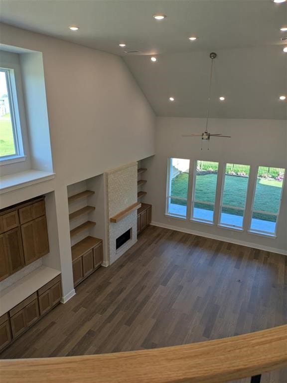 12039 Lake View Blvd, Mont Belvieu, TX 77523 - unfurnished living room featuring healthy amount of natural light, a fireplace, dark wood-style flooring, recessed lighting, and vaulted ceiling