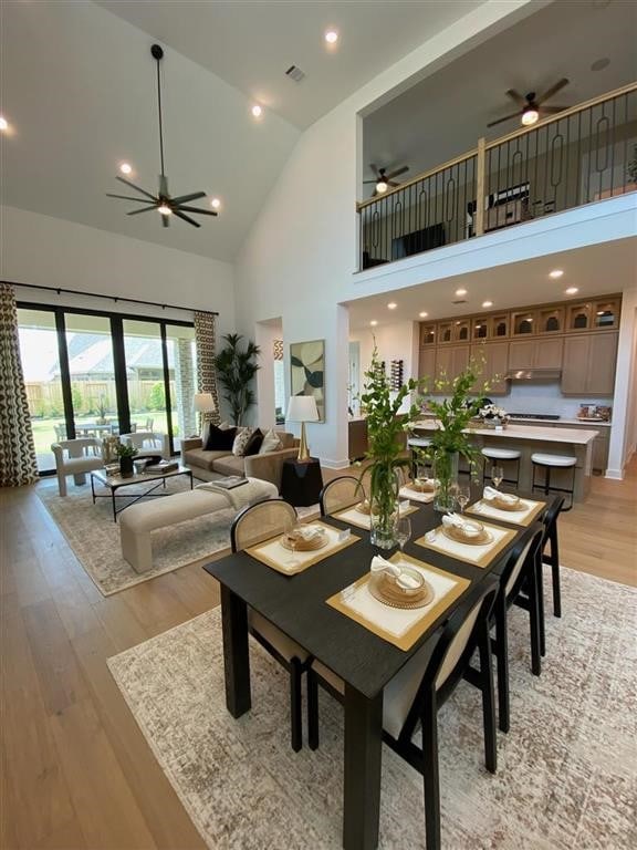 12039 Lake View Blvd, Mont Belvieu, TX 77523 - dining space featuring ceiling fan, high vaulted ceiling, and light wood-style flooring