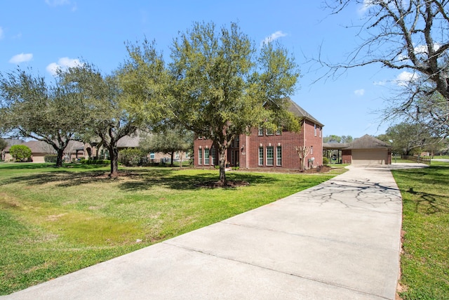 view of front of house featuring brick siding, a front yard, driveway, and a garage