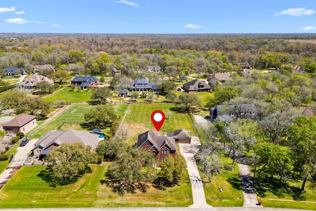 aerial perspective of suburban area featuring a heavily wooded area