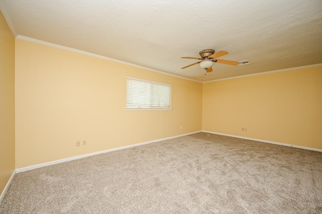 spare room with baseboards, a textured ceiling, crown molding, a ceiling fan, and carpet