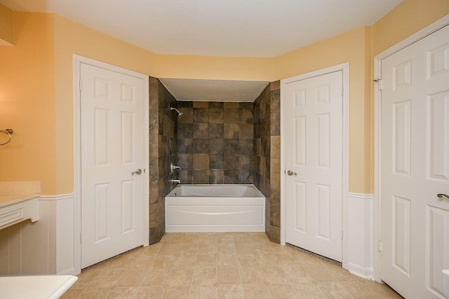 full bathroom with a wainscoted wall and shower / tub combination