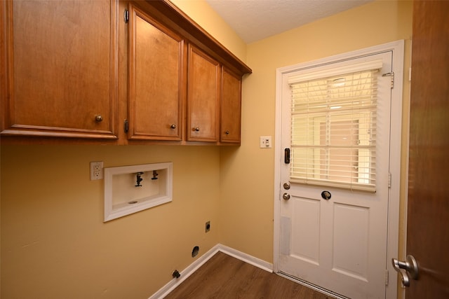 laundry room featuring dark wood finished floors, hookup for an electric dryer, washer hookup, baseboards, and cabinet space