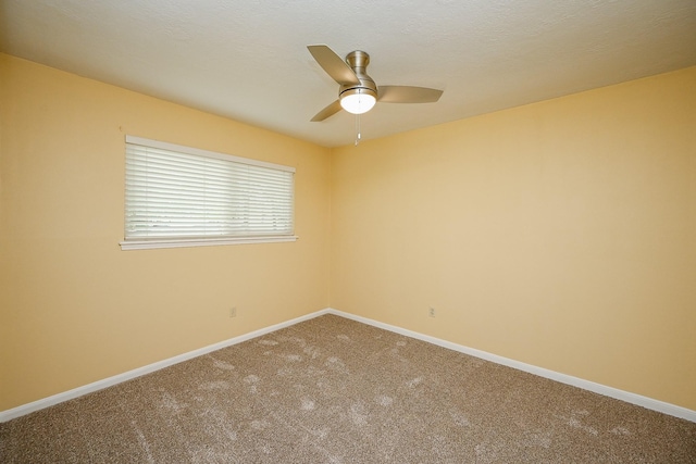 carpeted empty room featuring baseboards, a textured ceiling, and ceiling fan