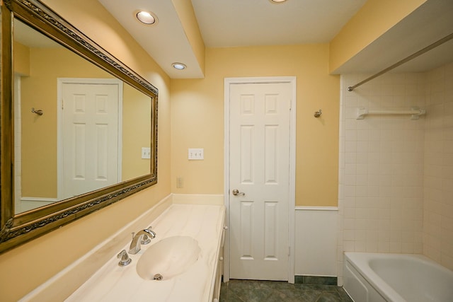 bathroom with shower / bath combination, vanity, baseboards, and recessed lighting