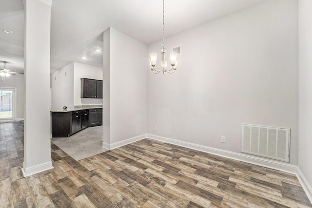 4306 Chadwick Rd, Texas City, TX 77591 - unfurnished dining area with visible vents, baseboards, wood finished floors, and ceiling fan with notable chandelier