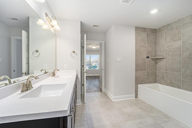 4306 Chadwick Rd, Texas City, TX 77591 - bathroom with double vanity, visible vents, baseboards, and a sink
