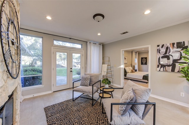 living area featuring recessed lighting, french doors, baseboards, and ornamental molding