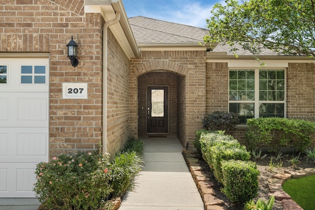 207 Cattle Ranch Dr, Richmond, TX 77469 - entrance to property with brick siding, an attached garage, and a shingled roof