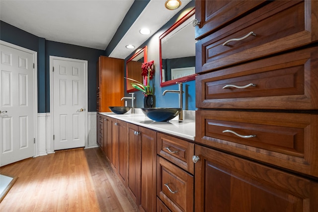 12635 Ivyforest Dr, Cypress, TX 77429 - full bath featuring wood finished floors, a sink, double vanity, and recessed lighting