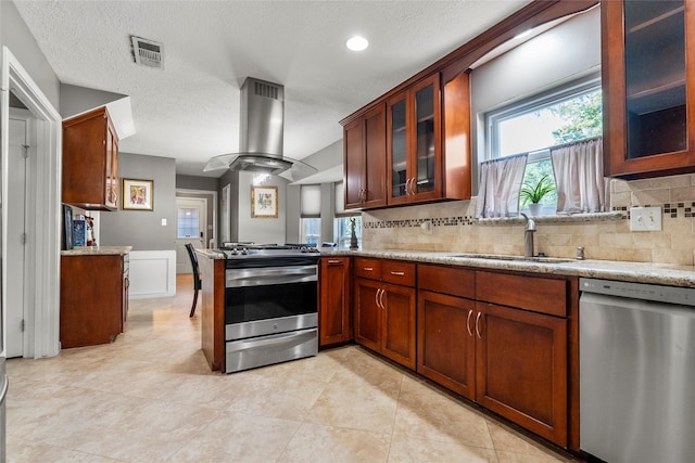 12635 Ivyforest Dr, Cypress, TX 77429 - kitchen featuring tasteful backsplash, island range hood, stainless steel appliances, and a sink