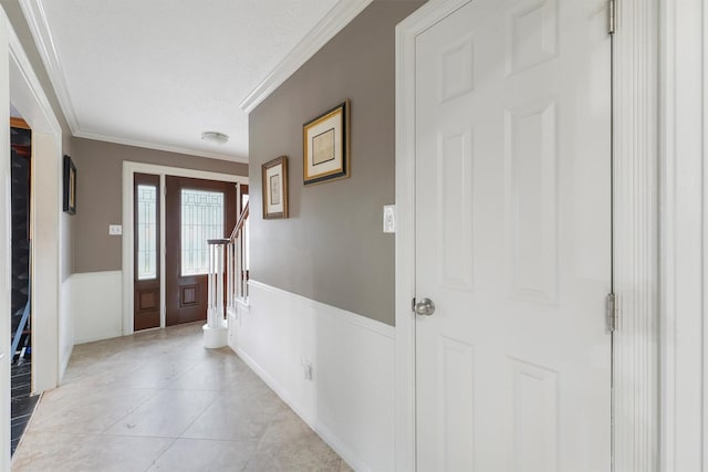 12635 Ivyforest Dr, Cypress, TX 77429 - entryway featuring wainscoting, light tile patterned floors, stairs, and ornamental molding