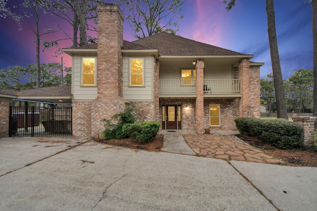 12635 Ivyforest Dr, Cypress, TX 77429 - view of front of house with brick siding, a shingled roof, concrete driveway, and a balcony