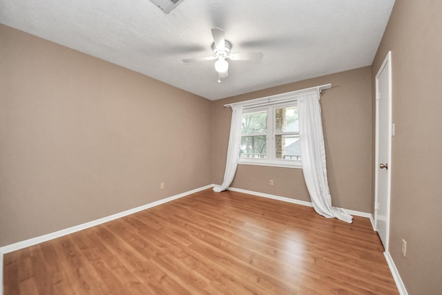 12635 Ivyforest Dr, Cypress, TX 77429 - empty room with light wood finished floors, a ceiling fan, baseboards, and visible vents