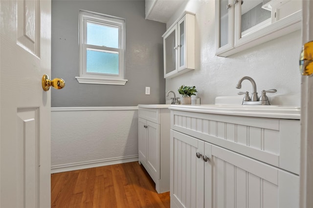 12635 Ivyforest Dr, Cypress, TX 77429 - bathroom with baseboards, a textured wall, vanity, and wood finished floors