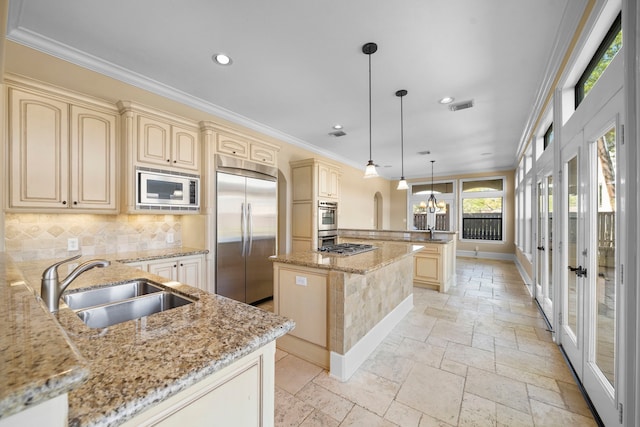 4628 Beech St, Bellaire, TX 77401 - kitchen with built in appliances, a sink, cream cabinetry, stone tile flooring, and a peninsula