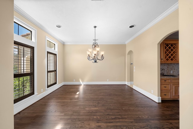 4628 Beech St, Bellaire, TX 77401 - spare room with dark wood-style flooring, a sink, ornamental molding, and a chandelier