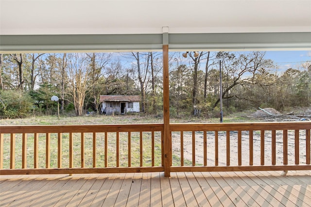 301 Pineland Dr, Trinity, TX 75862 - wooden terrace featuring a storage shed and an outdoor structure