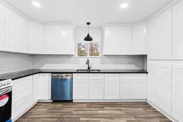301 Pineland Dr, Trinity, TX 75862 - kitchen featuring dark countertops, stainless steel appliances, dark wood-type flooring, and a sink