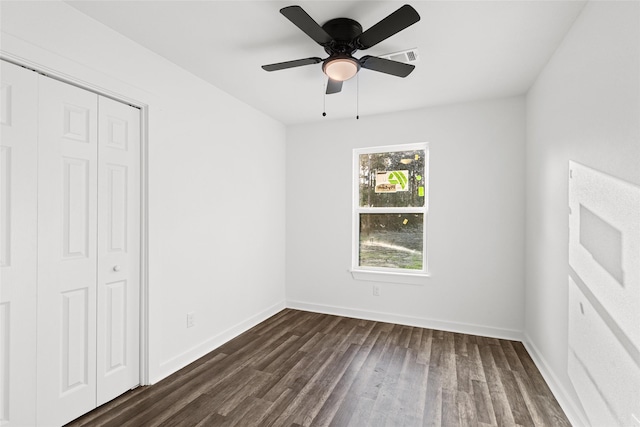 301 Pineland Dr, Trinity, TX 75862 - unfurnished bedroom featuring a closet, a ceiling fan, dark wood-type flooring, and baseboards