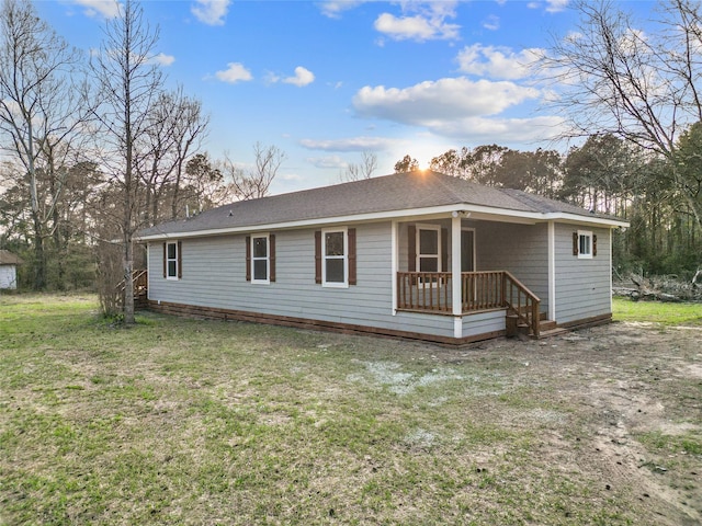 301 Pineland Dr, Trinity, TX 75862 - back of house with a lawn and a shingled roof