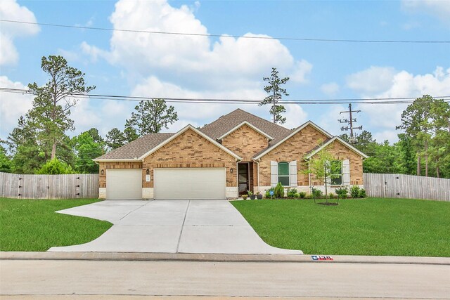 139 Jim Hall Ln, New Waverly, TX 77358 - view of front of home featuring an attached garage, brick siding, concrete driveway, a gate, and a shingled roof