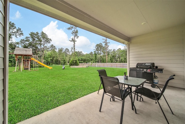 139 Jim Hall Ln, New Waverly, TX 77358 - view of patio featuring outdoor dining area, area for grilling, a playground, and view of wooded area