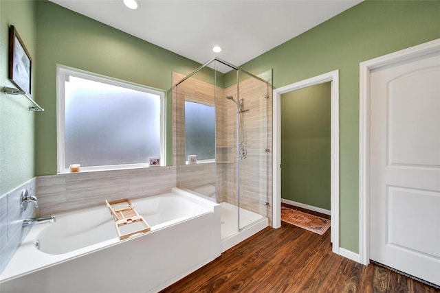 139 Jim Hall Ln, New Waverly, TX 77358 - bathroom featuring a shower stall, a garden tub, wood finished floors, and recessed lighting