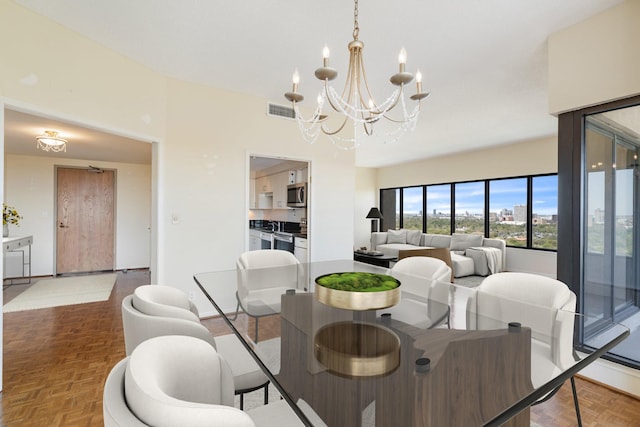 dining room featuring an inviting chandelier and visible vents