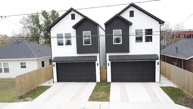 3038 Webster St, Houston, TX 77004 - view of front facade with a garage, fence, driveway, and a shingled roof